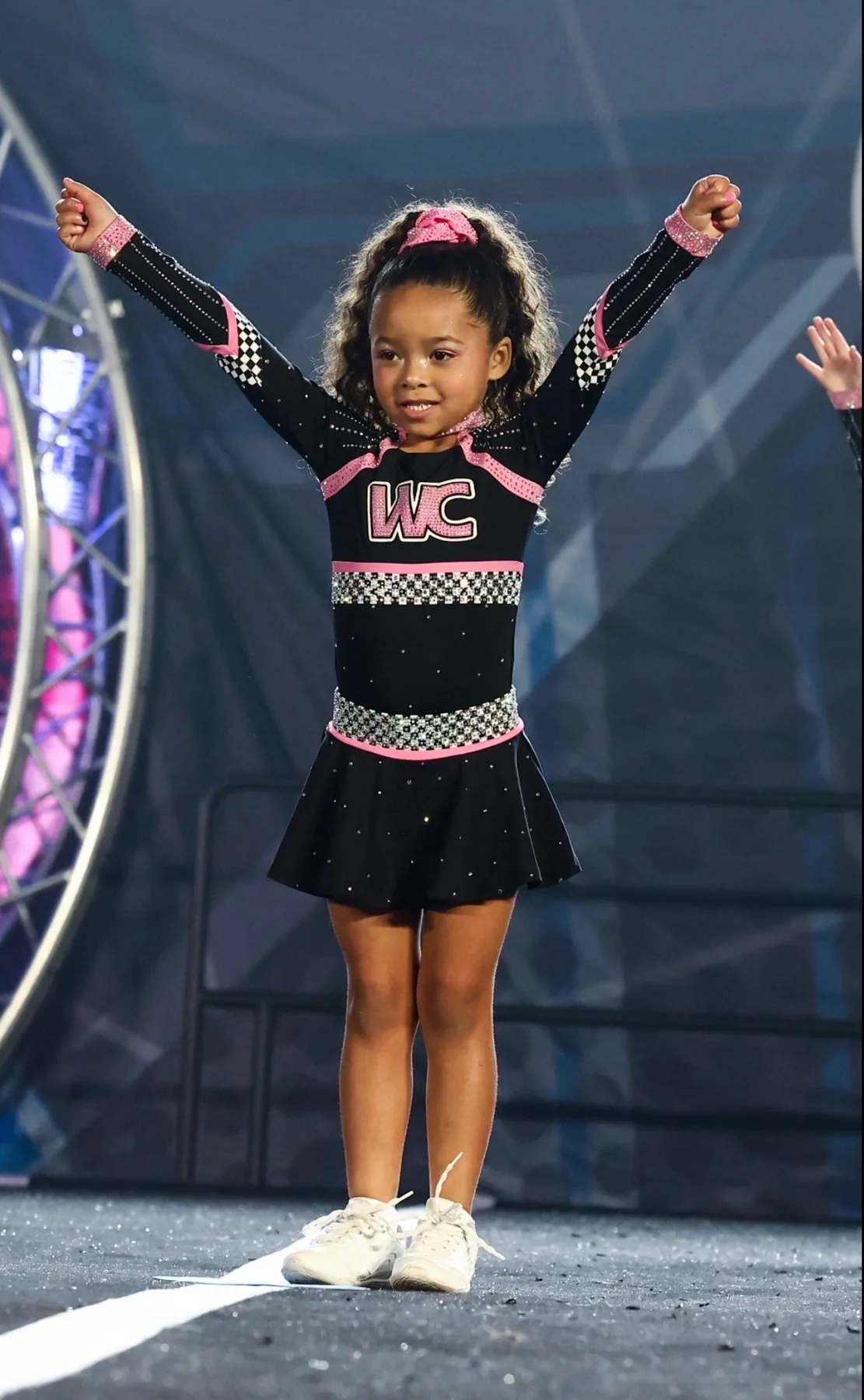 Young Winner Circle Athletics cheerleader smiling at competition